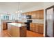 Well-lit kitchen featuring custom cabinets, an island with stone countertops, and a pantry at 6869 W Winding, McCordsville, IN 46055