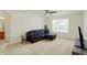 Well lit living room features neutral walls, a large window and comfortable seating at 6869 W Winding, McCordsville, IN 46055