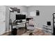 Well-lit home office featuring modern gray accents, ample desk space, and contemporary decor at 6869 W Winding, McCordsville, IN 46055