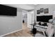 Well-lit home office featuring modern black desk, multiple screens, and contemporary decor at 6869 W Winding, McCordsville, IN 46055
