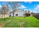 Large, grassy backyard with a view of the home and its covered patio at 701 Downing Dr, Greenwood, IN 46143