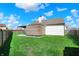 Lush green backyard with a modern wooden shed, perfect for outdoor enjoyment and relaxation at 701 Downing Dr, Greenwood, IN 46143