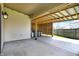 Covered backyard patio with an outdoor hot tub and exterior lighting at 701 Downing Dr, Greenwood, IN 46143