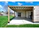 This home has a covered backyard patio surrounded by lush green grass at 701 Downing Dr, Greenwood, IN 46143