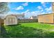 Spacious backyard features lush green grass, a shed, and a modern wooden structure at 701 Downing Dr, Greenwood, IN 46143