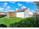 Well-maintained backyard features green grass, wooden privacy fence and wooden outdoor shed at 701 Downing Dr, Greenwood, IN 46143