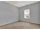 This carpeted bedroom features a single window and light gray walls at 701 Downing Dr, Greenwood, IN 46143