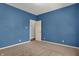 This bedroom features neutral carpeted floors and a closet with a door at 701 Downing Dr, Greenwood, IN 46143