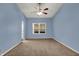 This bedroom features a ceiling fan and a window letting in natural light at 701 Downing Dr, Greenwood, IN 46143