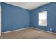 This bedroom features a window with a neutral carpeted floor at 701 Downing Dr, Greenwood, IN 46143