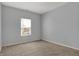 Bedroom featuring neutral walls and carpet with a window letting in natural light at 701 Downing Dr, Greenwood, IN 46143