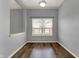 Cozy dining room featuring wood floors, neutral walls, and natural light from a window at 701 Downing Dr, Greenwood, IN 46143