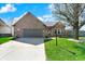Charming brick home with attached garage and well-maintained front lawn at 701 Downing Dr, Greenwood, IN 46143