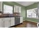 Bright kitchen featuring wooden floors, white cabinets and stainless steel appliances at 701 Downing Dr, Greenwood, IN 46143