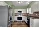 Stylish kitchen featuring stainless steel appliances, tile backsplash, and wooden floors at 701 Downing Dr, Greenwood, IN 46143