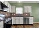 Updated kitchen featuring white cabinets, stainless appliances and tiled backsplash at 701 Downing Dr, Greenwood, IN 46143