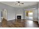 Open living room featuring a fireplace, sliding glass doors, and hardwood flooring at 701 Downing Dr, Greenwood, IN 46143