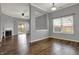 Open-concept living room with fireplace, wood floors, and sliding door access to the outdoor space at 701 Downing Dr, Greenwood, IN 46143