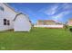 Backyard with outbuilding and lush green grass at 7048 Millet Ln, Avon, IN 46123
