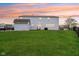 Large backyard with lush green grass, a storage shed, and ample space for outdoor activities at 7048 Millet Ln, Avon, IN 46123