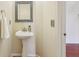 Stylish pedestal sink with framed mirror in a well-lit half bathroom at 7048 Millet Ln, Avon, IN 46123