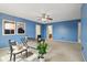 Lovely bedroom with blue walls, neutral carpet, ceiling fan and modern décor at 7048 Millet Ln, Avon, IN 46123