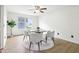 Cozy dining area features a round table, four chairs, and ample natural light at 7048 Millet Ln, Avon, IN 46123