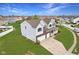 Charming two-story home with a well-manicured lawn, two-car garage, and inviting front porch at 7048 Millet Ln, Avon, IN 46123