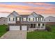Attractive two-story home featuring a brick and siding exterior with a well-maintained lawn at 7048 Millet Ln, Avon, IN 46123