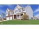 Charming home featuring a covered porch, brick accents, and well-manicured lawn at 7048 Millet Ln, Avon, IN 46123