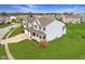 A two-story home boasts a two-car garage and well-kept lawn in a suburban neighborhood at 7048 Millet Ln, Avon, IN 46123
