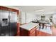 Modern kitchen with stainless appliances that flows into the living room and dining area at 7048 Millet Ln, Avon, IN 46123