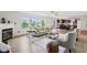 Bright living room with fireplace, large windows, and view into updated kitchen at 7048 Millet Ln, Avon, IN 46123