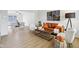 Living room with leather sofa, modern decor, and an open view to the dining area at 7048 Millet Ln, Avon, IN 46123