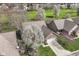 Aerial view of brick home with manicured lawn and golf course view at 7242 River Glen Dr, Fishers, IN 46038