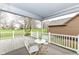 Covered back porch with chairs, table, and scenic view at 7242 River Glen Dr, Fishers, IN 46038