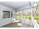 Covered back porch with chairs, table, and scenic view at 7242 River Glen Dr, Fishers, IN 46038