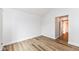 Bright bedroom with wood-look flooring and en suite bathroom access at 7242 River Glen Dr, Fishers, IN 46038