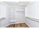 Walk-in closet with vinyl floors and white shelving and clothes rods at 7242 River Glen Dr, Fishers, IN 46038