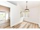 Dining area with hardwood floors, lots of natural light, and modern light fixture at 7242 River Glen Dr, Fishers, IN 46038