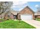 Beautiful brick home with manicured lawn, flowering tree, and two-car garage at 7242 River Glen Dr, Fishers, IN 46038
