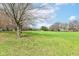 Scenic golf course view with mature trees and open green space, ideal for golf enthusiasts and outdoor recreation at 7242 River Glen Dr, Fishers, IN 46038