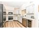 Modern kitchen with stainless steel appliances, granite countertops, and white cabinets at 7242 River Glen Dr, Fishers, IN 46038