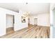 Open-concept living room with hardwood floors, flowing into the kitchen space at 7242 River Glen Dr, Fishers, IN 46038