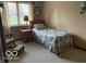 Bedroom with a twin bed, wooden side table, and a window view at 7664 Lincoln Trl, Plainfield, IN 46168