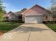 Charming single-story home with a brick facade and a two-car garage at 7664 Lincoln Trl, Plainfield, IN 46168