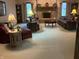Spacious living room featuring a brick fireplace, plush sofas, and a neutral carpet at 7664 Lincoln Trl, Plainfield, IN 46168