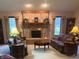 Inviting living room featuring a brick fireplace and comfortable seating arrangement at 7664 Lincoln Trl, Plainfield, IN 46168