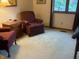 Sitting room with comfortable upholstered armchairs, a small wood dresser, and a carpeted floor at 7664 Lincoln Trl, Plainfield, IN 46168