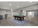 Spacious finished basement featuring a pool table, bar area, and ample lighting at 7736 Eagle Point Cir, Zionsville, IN 46077